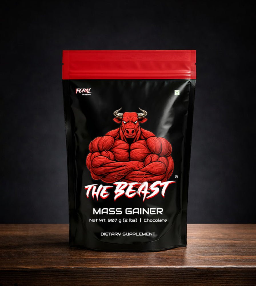 The Beast Mass Gainer 907g chocolate supplement pouch with muscular bull logo on wooden table.